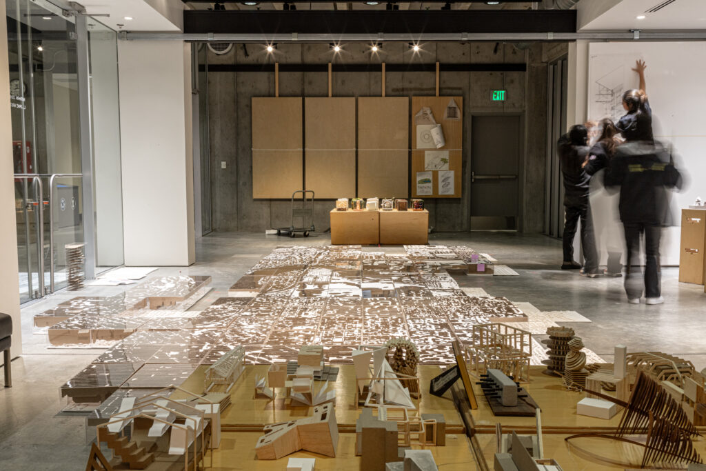 Students organizing artwork in Gould Hall gallery